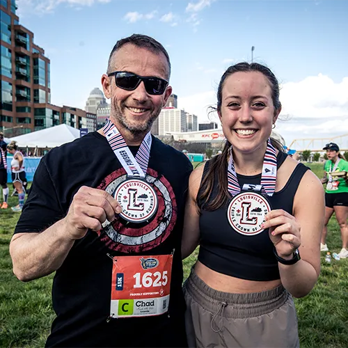 dad and daughter post race medals