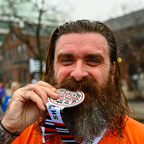 man biting medal