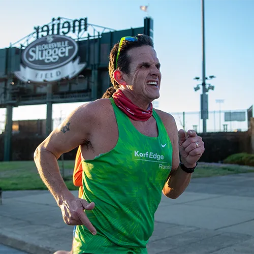 man in green shirt running