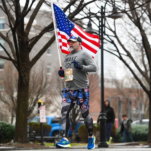 man jogging with the American flag