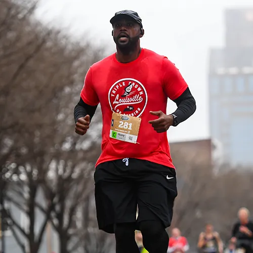 man running in red shirt