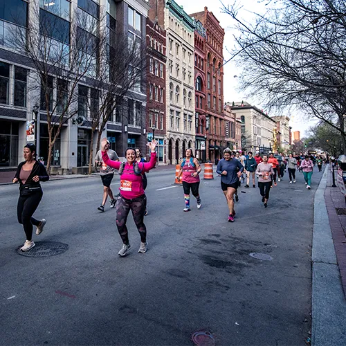 people running down street