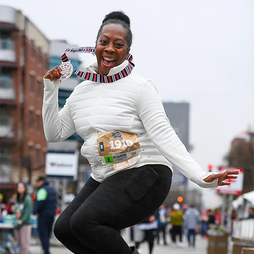 excited 5k finisher with medal